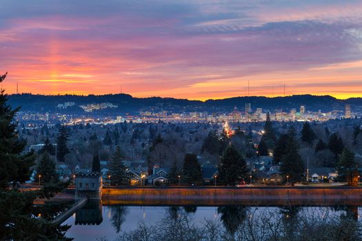 Colorful sunset over Mt Tabor City Park Reservior and the skyline of Portland Oregon downtown