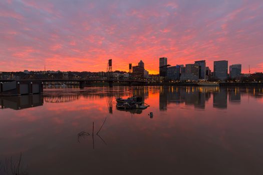 Fiery sunset over Portland Oregon skyline along Willamette River by Hawthorne Bridge