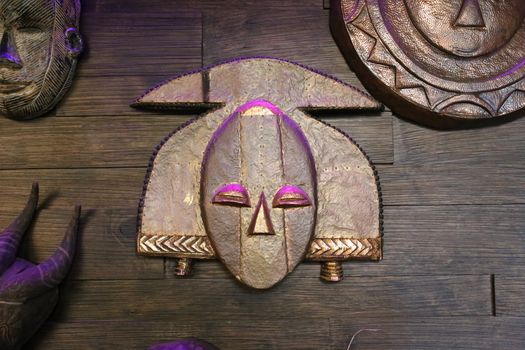 Inca mask on the wooden wall