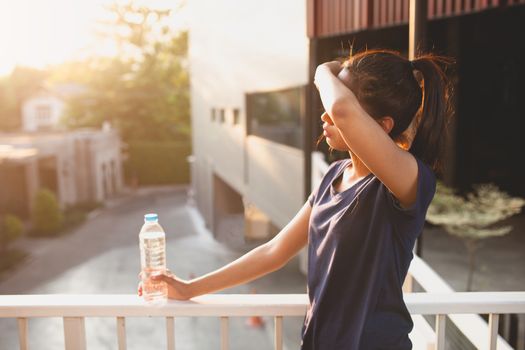 Sports women relax time and drinking water.