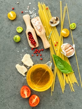 Italian food concept. Spaghetti with ingredients sweet basil ,tomato ,garlic peppercorn ,champignon,zucchini and parmesan cheese on dark background flat lay and copy space.