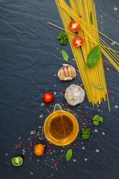 Italian food concept. Spaghetti with ingredients sweet basil ,tomato ,garlic peppercorn ,champignon,zucchini and parmesan cheese on dark background flat lay and copy space.