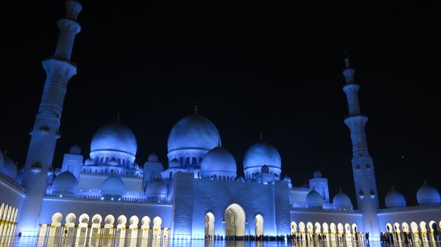 The beautifully lit huge grand mosque in Abu Dhabi, United Arab Emirates.                               