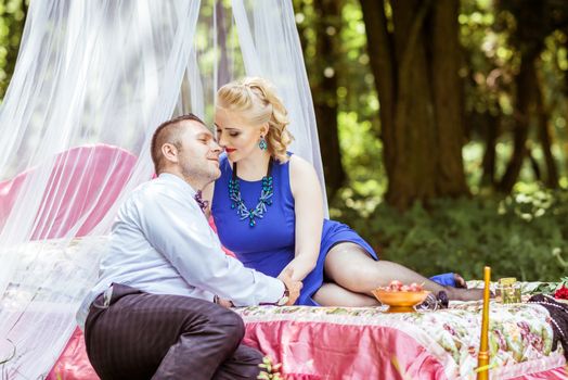 Man and woman sitting on the bed and looking at each other in the lawn in Lviv, Ukraine.