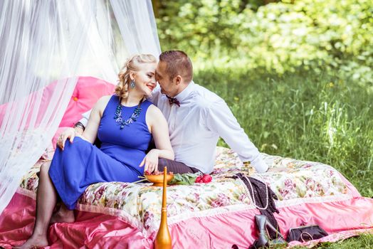 Man and woman sitting on the bed and looking at each other in the lawn in Lviv, Ukraine.