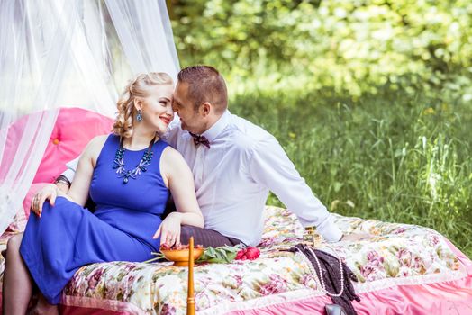 Man and woman sitting on the bed and looking at each other in the lawn in Lviv, Ukraine.