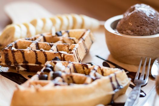 Belgian waffles with fruit and chocolate, forest fruit, all homemade, delicious batter