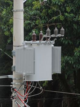 Electric transformer attached to a concrete pole