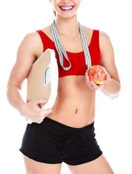 Smiling fit woman with scale and apple, isolated on white background