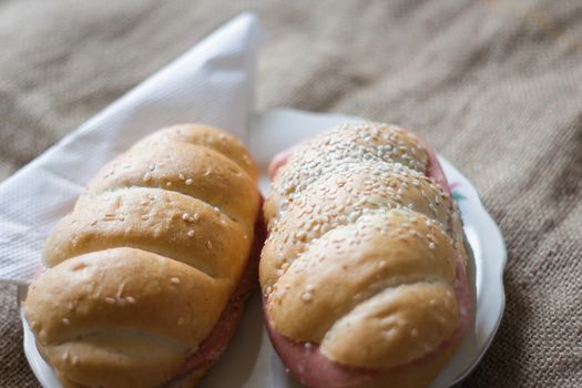 buns on a plate with a napkin on a light blurred background