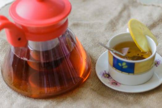 photo top view of tea cup with tea kettle