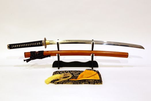 Japanese sword on stand with white background