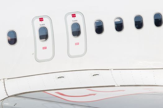 Windows of airplane with emergency exit door