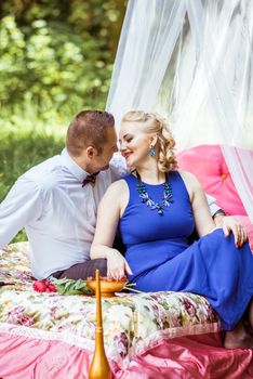 Man and woman sitting on the bed and looking at each other in the lawn in Lviv, Ukraine.