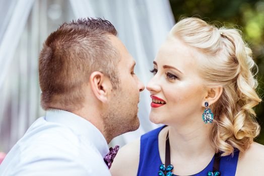 Man and woman sitting on the bed and looking at each other in the lawn in Lviv, Ukraine.