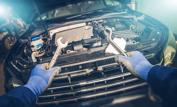 Broken Car Confrontation. Car Mechanic with Wrenches in Hands Preparing For Big Fix. Vehicle Fixing.
