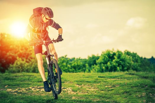 Extreme Mountain Biking. Summer Recreation and Sports Concept. Caucasian Biker.