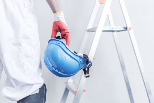 Hard Hat Construction Safety. Construction Worker with Construction Helmet in Hand.