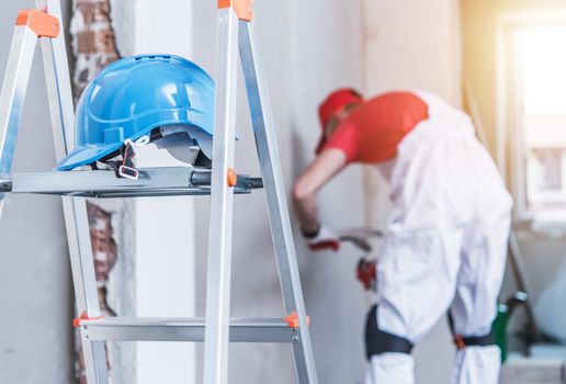 Hard Hat Left on the Ladder. Construction Safety Concept.