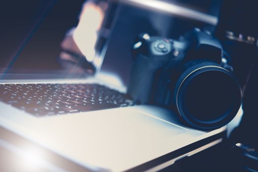 Microstock Photo Business Concept Photo with DSLR Camera and Modern Laptop Workstation For Photography Editing.