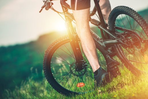 Nature Trail Biking. Caucasian Biker on His Mountain Bike Closeup Photo. Summer Recreation.