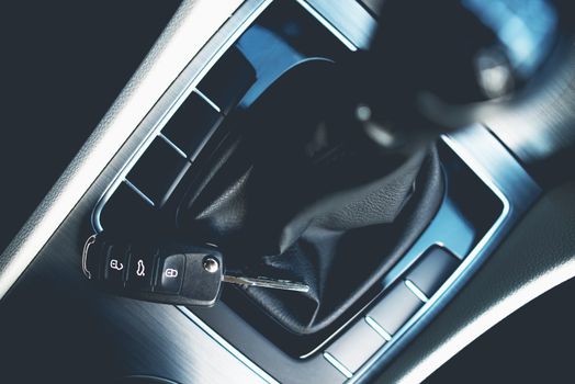 New Car Buying Concept. Stick Shift, Car Cockpit and the Car Keys Closeup.