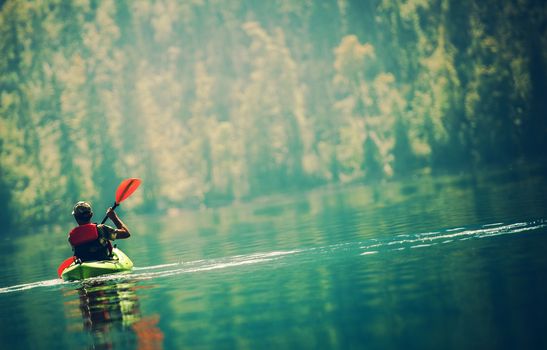 Scenic Kayak Lake Tour. Senior Kayaker on the Lake.