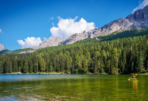 Scenic Kayak Touring on the Italian Alps Lake. Caucasian Outdoor Man in the Kayak.