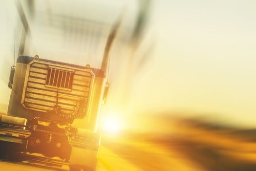 Trucking and Transport Concept Photo Background. Truck on the Highway During Sunset.