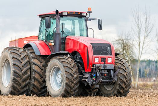 Farmer tractor working in the field. Spring time for sowing. Planting crops. 