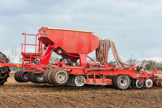 Farmer tractor working in the field. Spring time for sowing. Planting crops. 