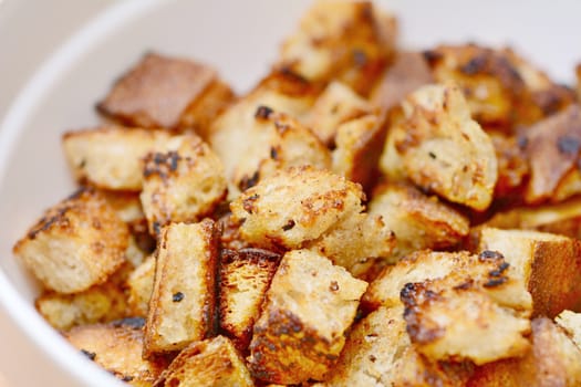 Closeup of Bread Croutons in White Bowl.