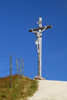 Cross on the top of a mountain in Dolomites, Italy