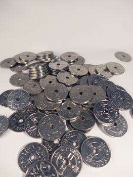lots of norwegian coins kroner on a white background