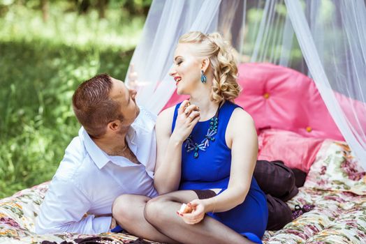 Man and woman sitting on the bed and looking at each other in the lawn in Lviv, Ukraine.