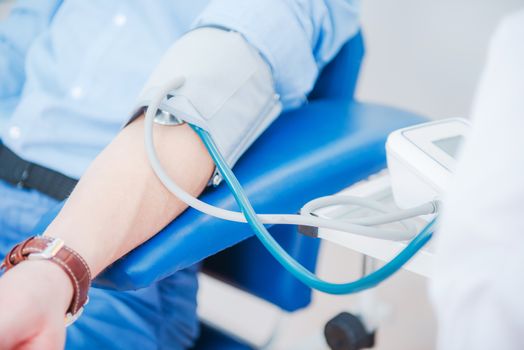 Blood Pressure Measurement. Doctor Measuring Blood Pressure Using Professional Hospital Equipment.
