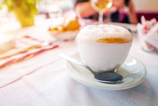 Foamy Tasteful Cappuccino Breakfast. Cup of Cappuccino Coffee on the Table.