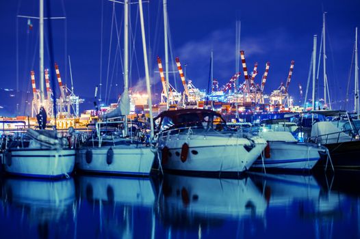 La Spezia Marina Yachts and Container Cargo Terminal in the Background. La Spezia, Liguria, Italy. Night Time Photo.