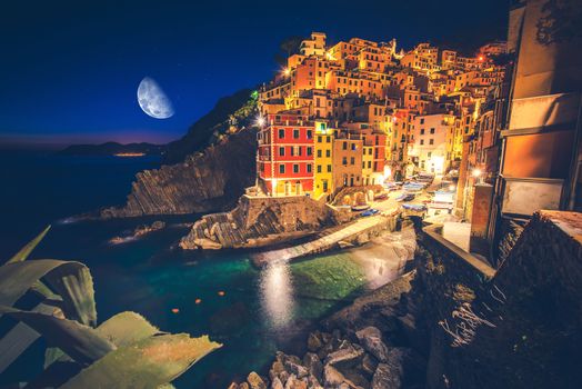 Colorful Italian Illuminations and Reflections. Riomaggiore Village at Night. La Spezia Region. Liguria, Italy.
