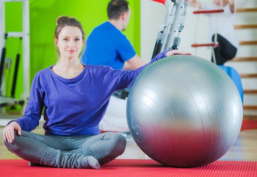 Exercise Ball Exercises For a Fit Body. Caucasian Woman in Her 30s with the Fitness Ball.