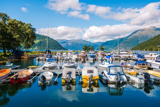 Fjord Marina in Norway. Small Village Marina with Motorboats and Fishing Boats. Norwegian Landscape.
