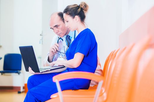 Hospital Staff at Work. Medical Doctor Consulting Imaging Tests with Female Radiologist. 