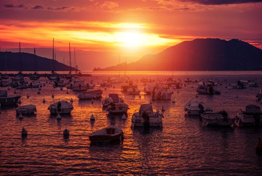 Italian Riviera Sunset. Yachts and Fishing Boats in the Marina. Liguria, Italy.