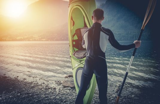 Pro Kayaker with His Kayak. Caucasian Sportsman is About to Take His First on the Season Kayak Tour on the Scenic Mountain Lake.