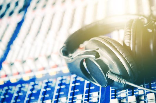 Recording Studio Headphones on the Audio Mixer Board. Closeup Photo. Music and Show Business Concept.