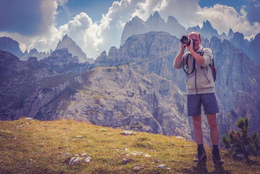 Senior Nature Photographer with Passion. Men in His 50s Taking Nature Images in the Scenic Region of Italian Dolomites.