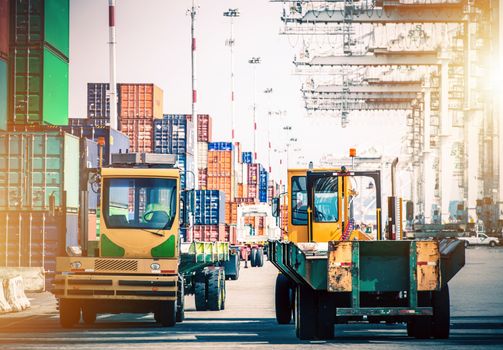 Forklift Tractors in Shipping Cargo Hub. Shipping Containers Distribution. Logistic and Shipping.
