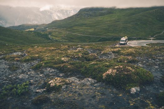 RV Trip in Scandinavia. Wild Norway Mountains Landscape and the Camper Van on the Road.