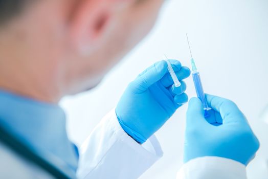 Syringe Injection by Doctor. Medical Doctor Preparing For Injection.