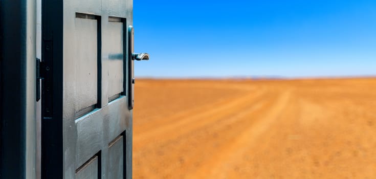 Opened door concept to beautiful and imaginary desert landscape